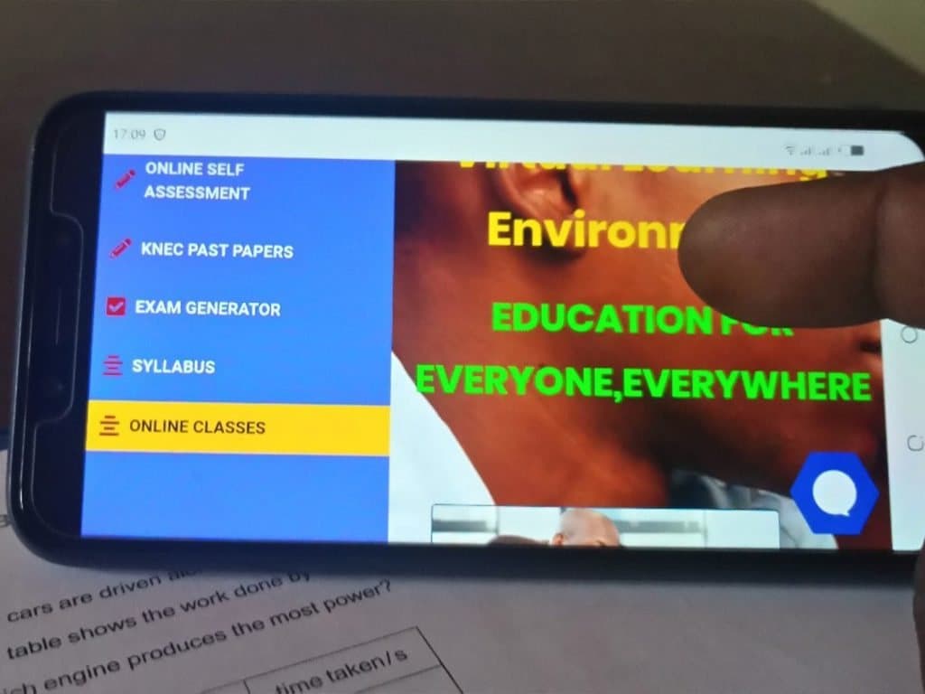 REACH-Education's mobile learning app on a smartphone, with menus for online self-assessment, KNEC past papers, an exam generator, the syllabus and online classes